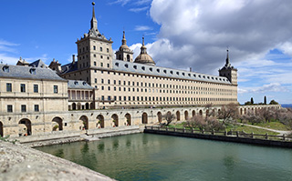 A view of a historic building along a river in Madrid, Spain.