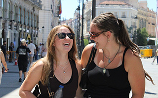 Students walking down a historic area while on a field trip in Spain.
