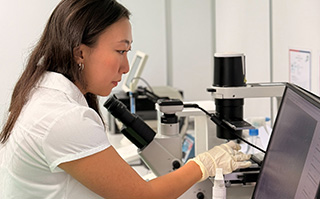 A student looking into a microscope in a lab in Khon Kaen, Thailand.
