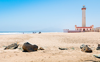 A view of the historic lighthouse and beach in La Serena, Chile.