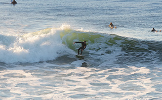 A person surfing the ocean waves in Pichilemu, Chile