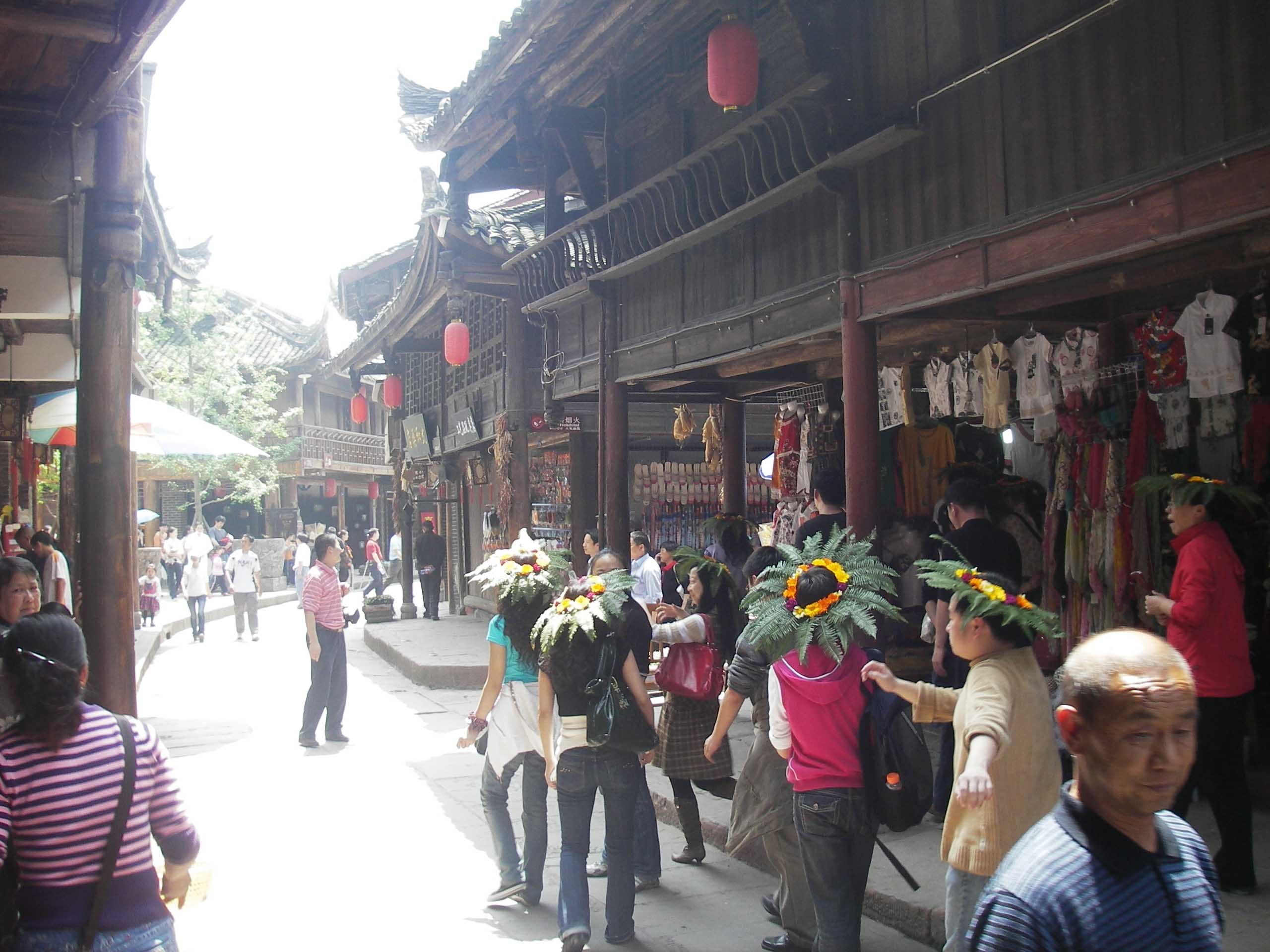 People walking down the street in Yellow Dragon Town in China.