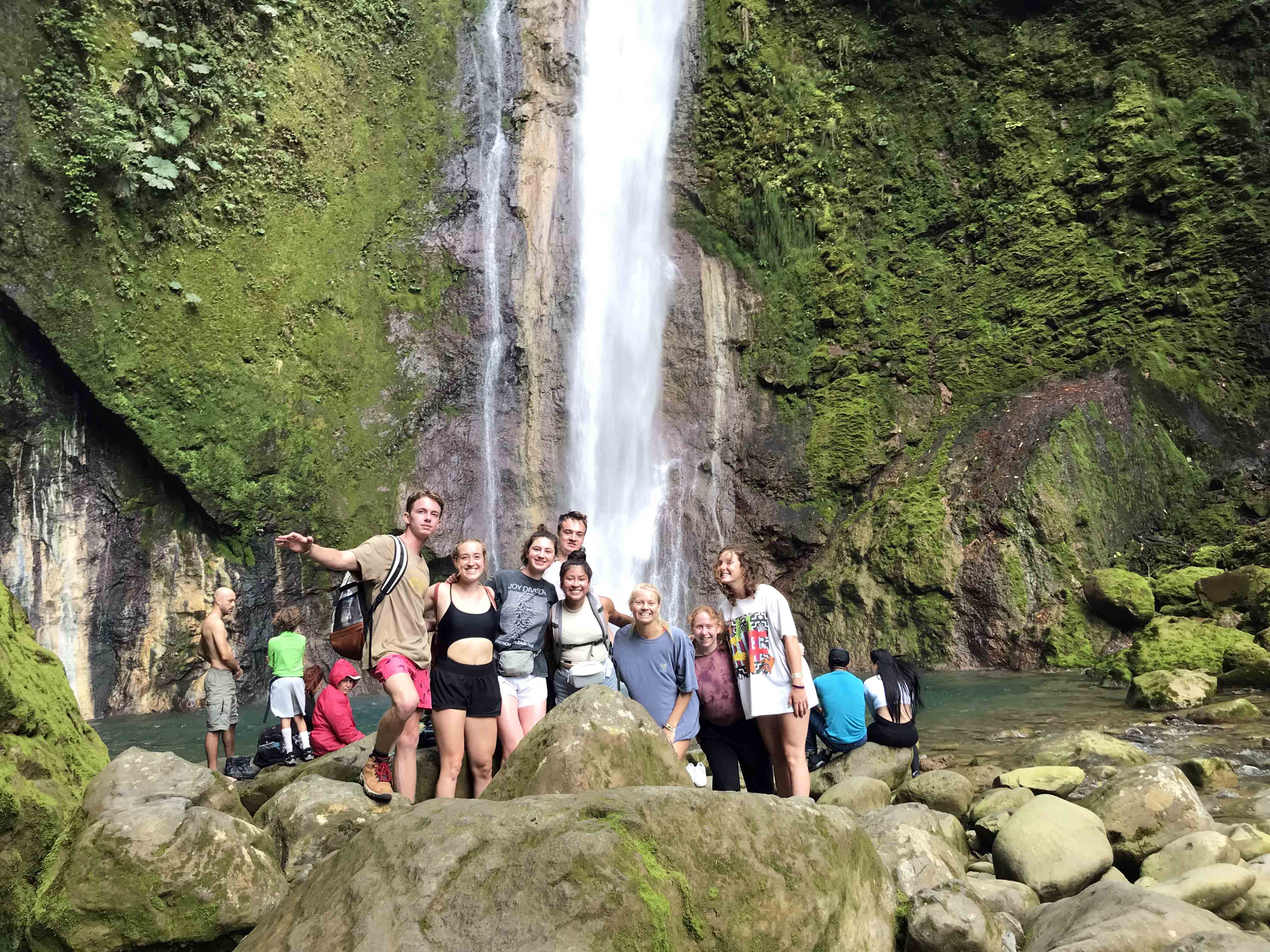 A group of students standing at the base of the Bajos del Toro waterfall in Costa Rica