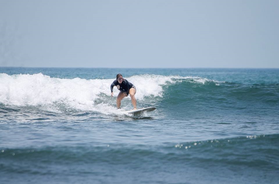 A student surfing at Jaco beach in Costa Rica