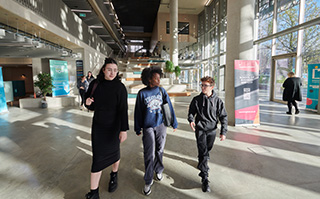 Students walking in the Elm House building at the University of Brighton in Brighton, England.