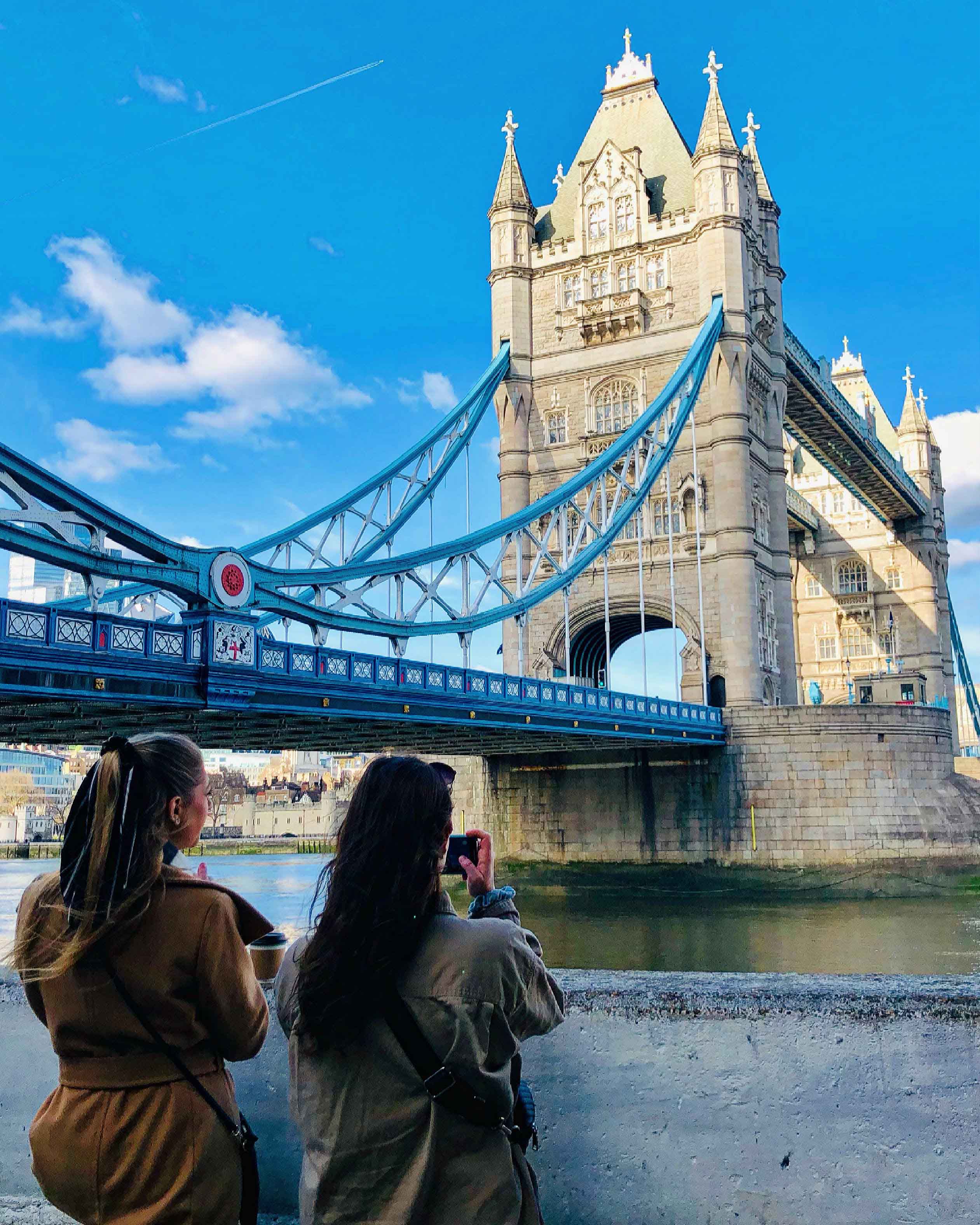 Two students taking in the views of the Tower Bridge in London, England.