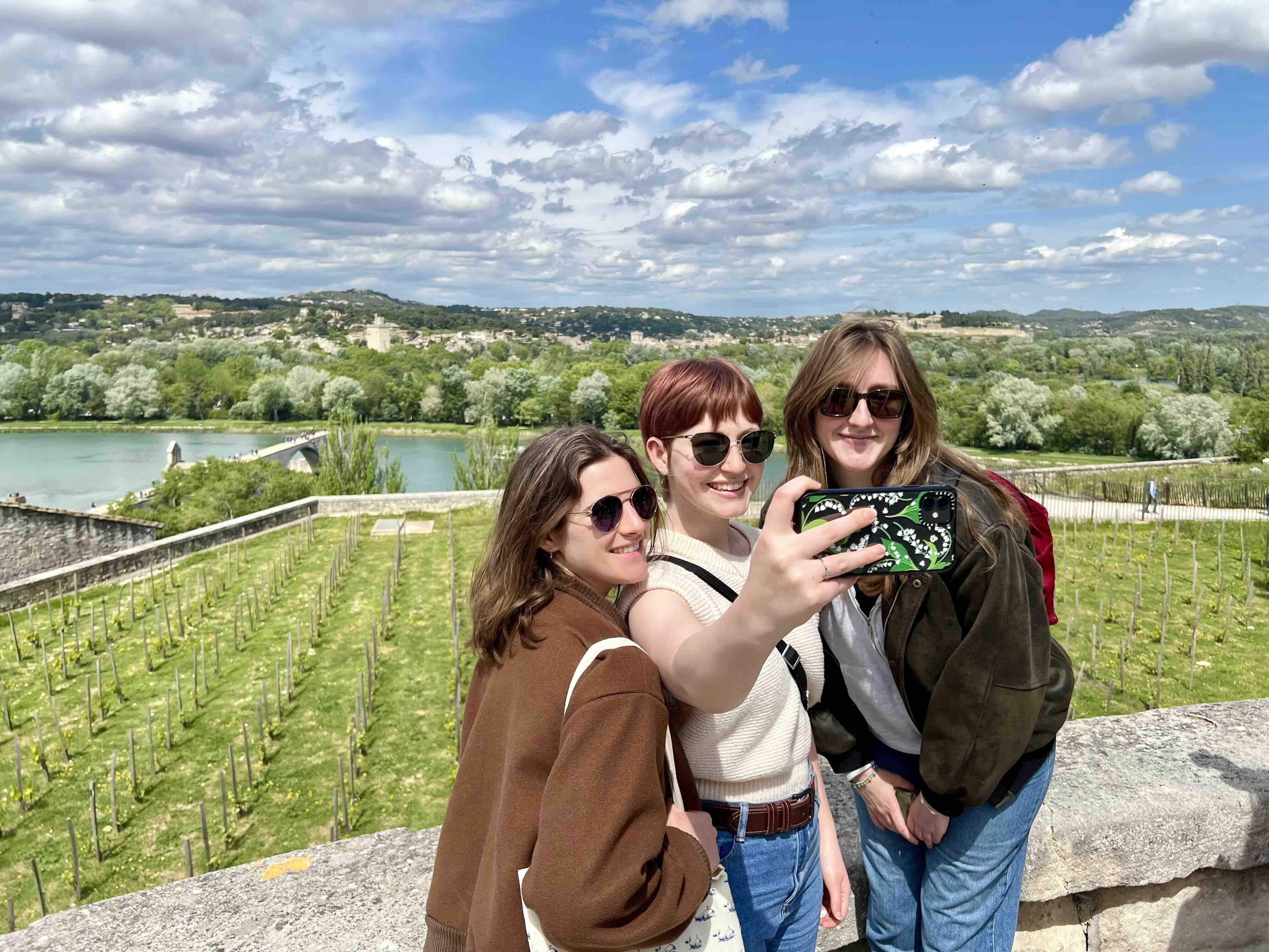 Students taking a selfie with Avignon, France in the background.