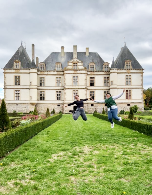 Two students jumping in front of the Beaune Historical Center in Bourgogne, France.