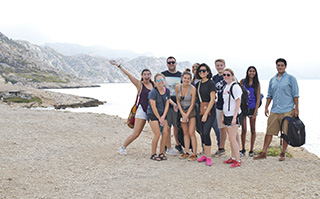 A group of students on the beach during a field study in Calanque outside of Marseille, France.