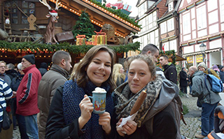 Two women exploring the famous Christmas Market in Celle, Germany.