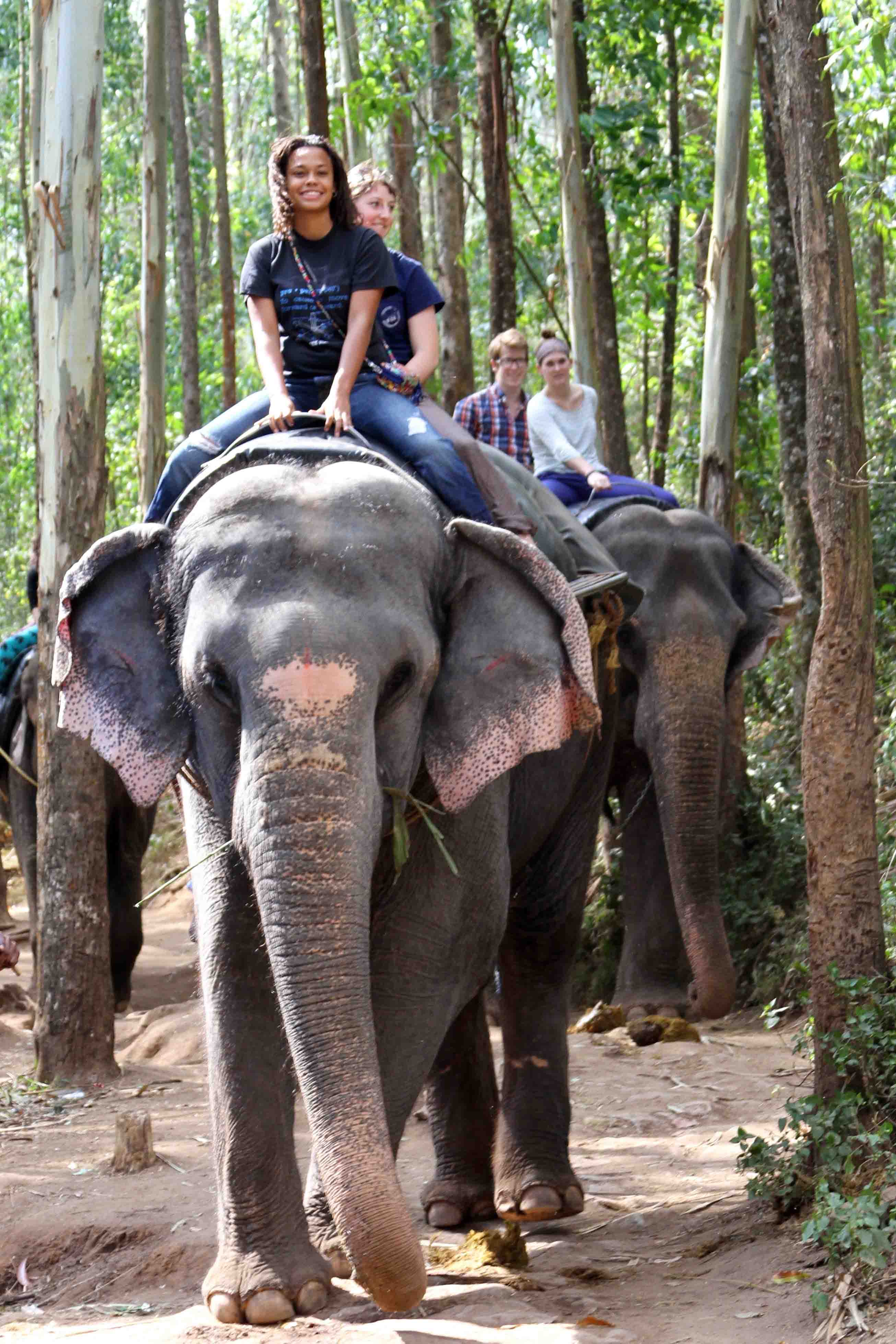 Students riding an elephant in Bengaluru, India.