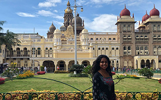 A woman standing in front of the Maharaja's palace in Mysore, India.