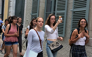 A group of people walking the streets of Pau, France sightseeing.