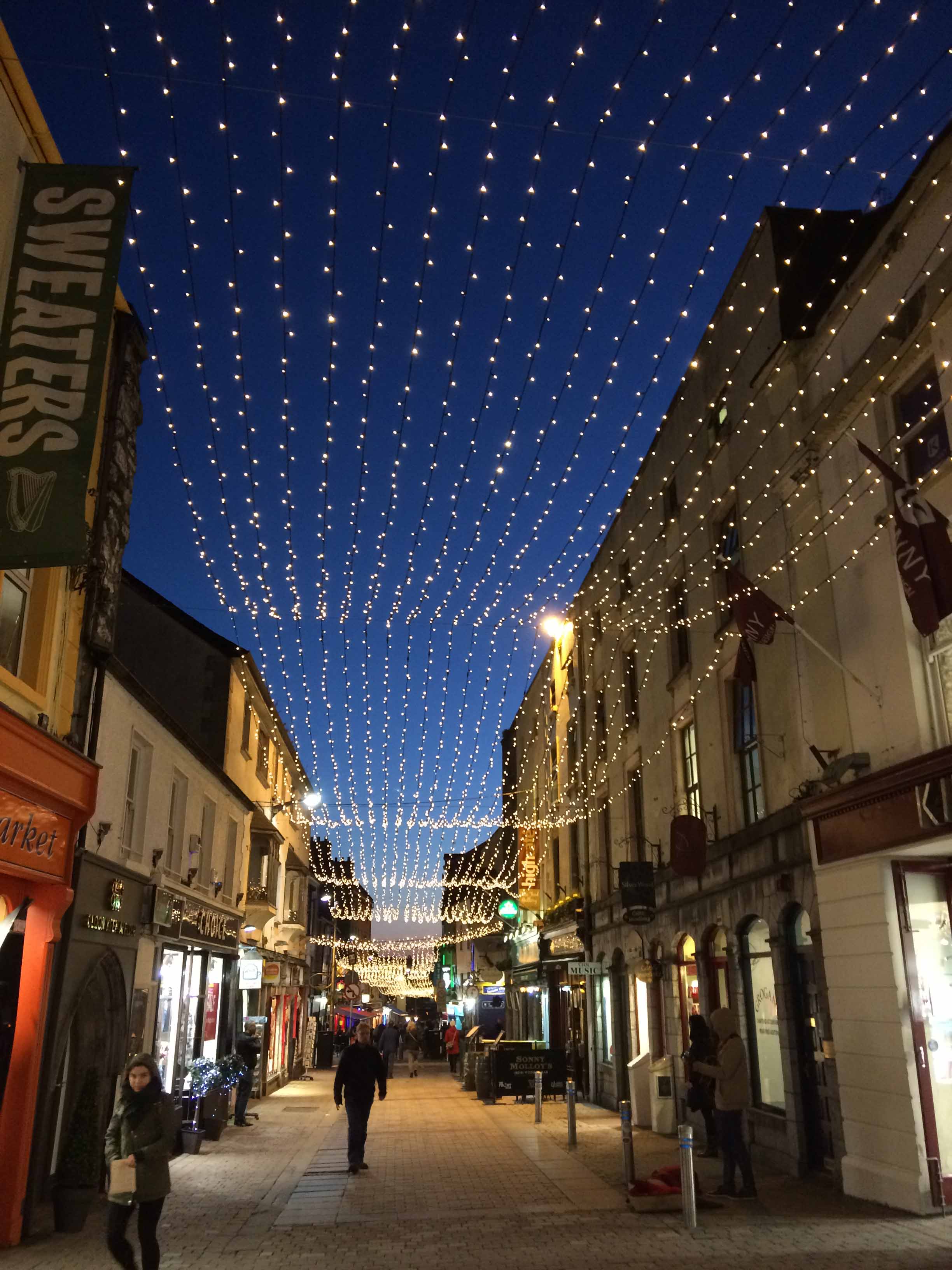 Streets lit up at night in Galway, Ireland.