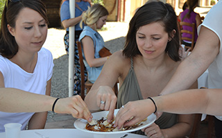 Two people enjoying their balsamic vinegar tasting in Acetaia, Italy.