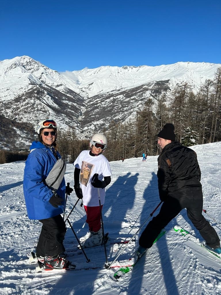 Three people skiing in the Italian Alps.