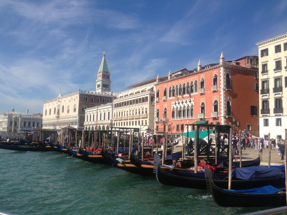 A view of the buildings and gondolas of Venice, Italy from the water.