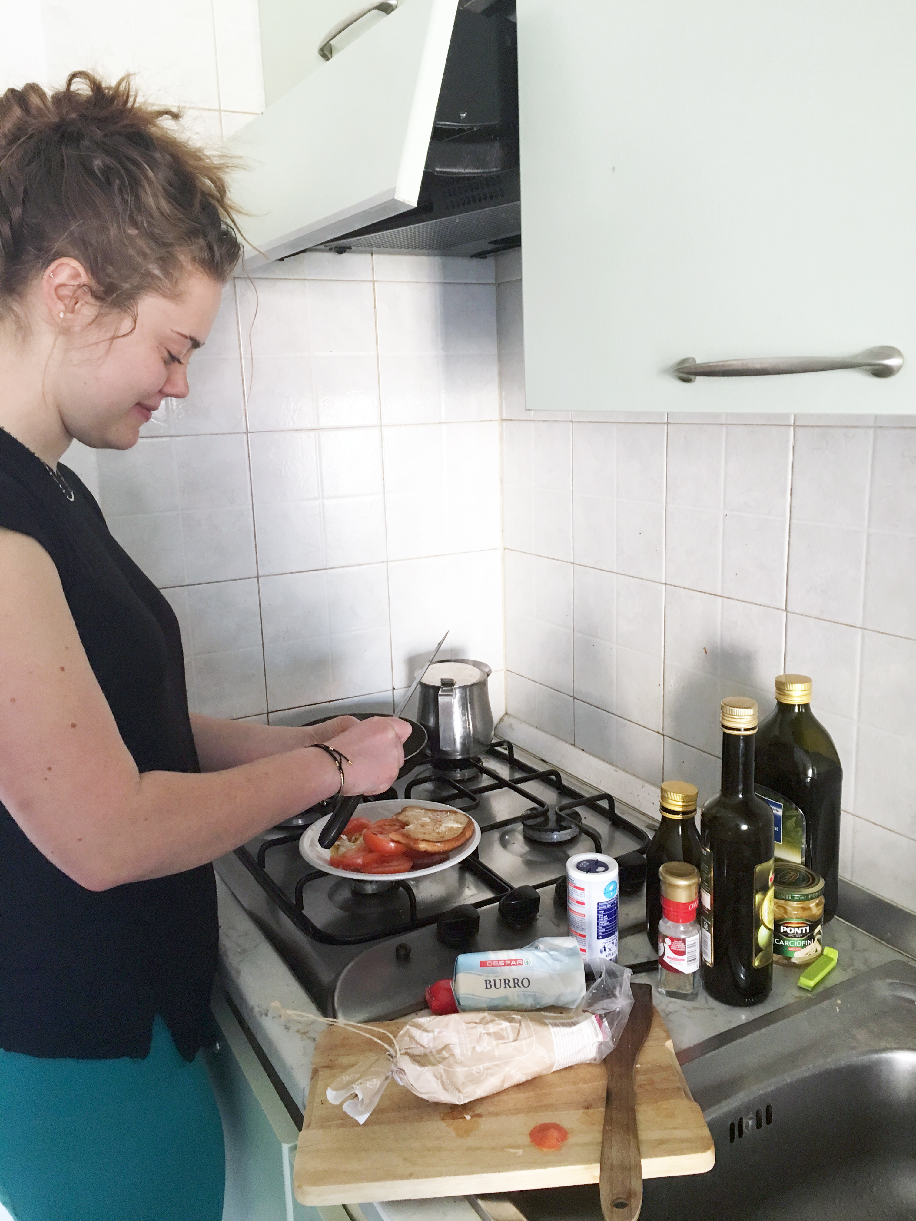 Student making dinner in the residence hall kitchen in Verona, Italy.