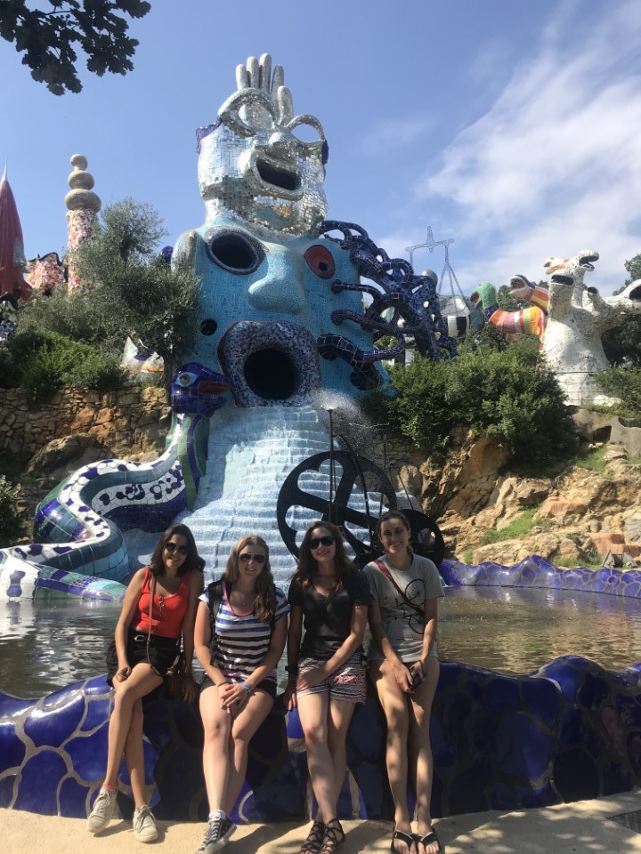 Students in front of a sculpture in the Tarot Garden in Italy.