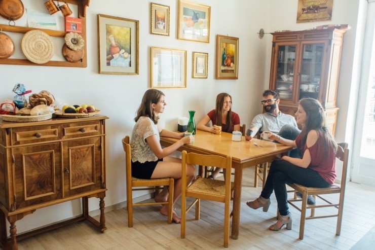 Students sitting around the dining table at the home of their host family in Viterbo, Italy.