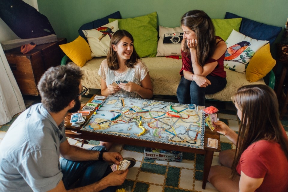 Students playing a board game with their host family in Reggio Emilia, Italy.
