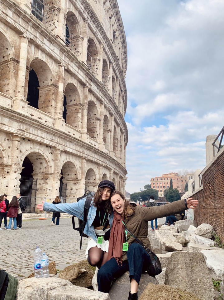 Two women outside the Colosseum in Rome, Italy.