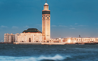 A view of the Hassan II Mosque at night in Casablanca, Morocco.