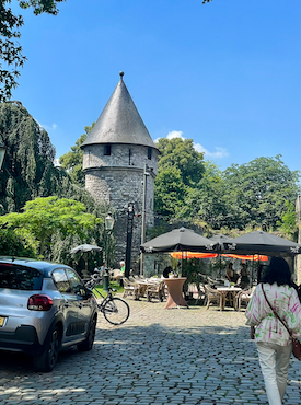 View of a cobblestone street and medieval wall in Maastricht, Netherlands.