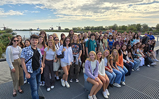 A group of students posing along a river in Maastricht, Netherlands.