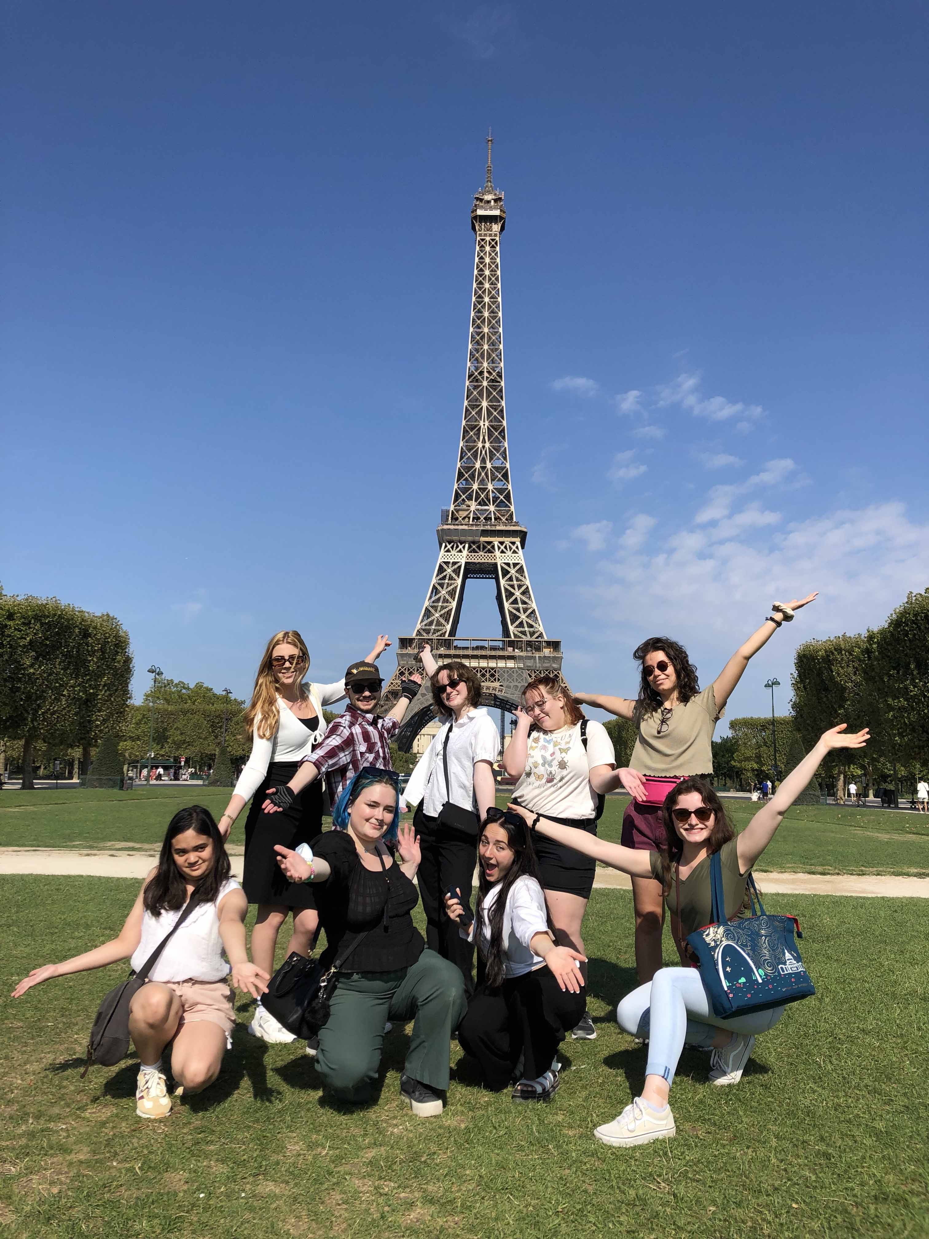 Students posing in front of the Eiffel Tower in Paris, France.