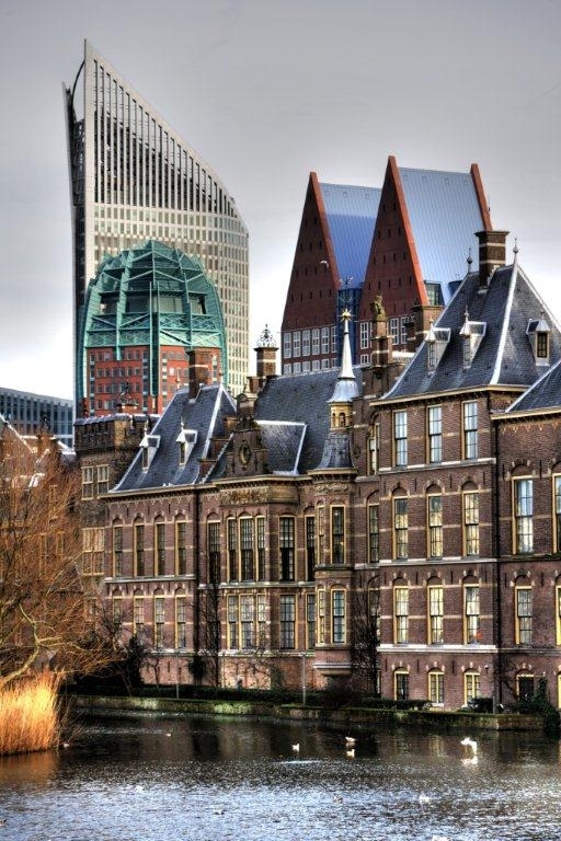 Historic and modern buildings lining the river in The Hague, Netherlands.