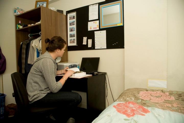 Student in a bedroom of the Cube student housing at Massey University in Wellington, New Zealand.