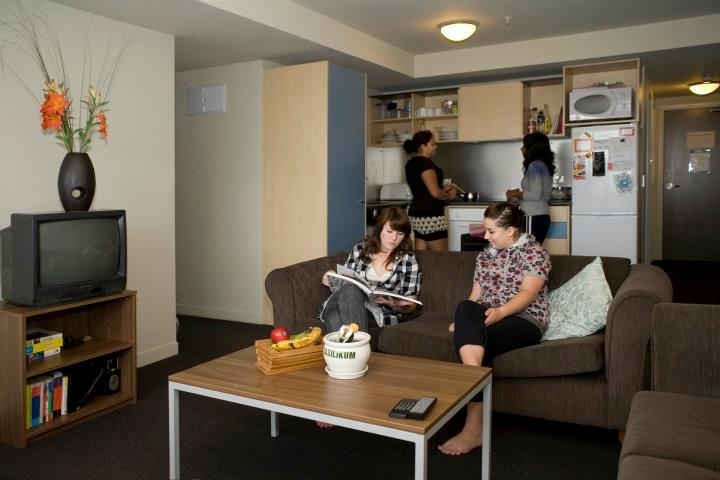 Students in the living room of the Cube student housing at Massey University in Wellington, New Zealand.