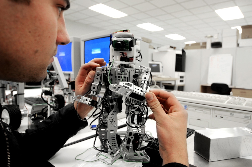 A student working on a robot at the Albany Campus of Massey University in Auckland, New Zealand.