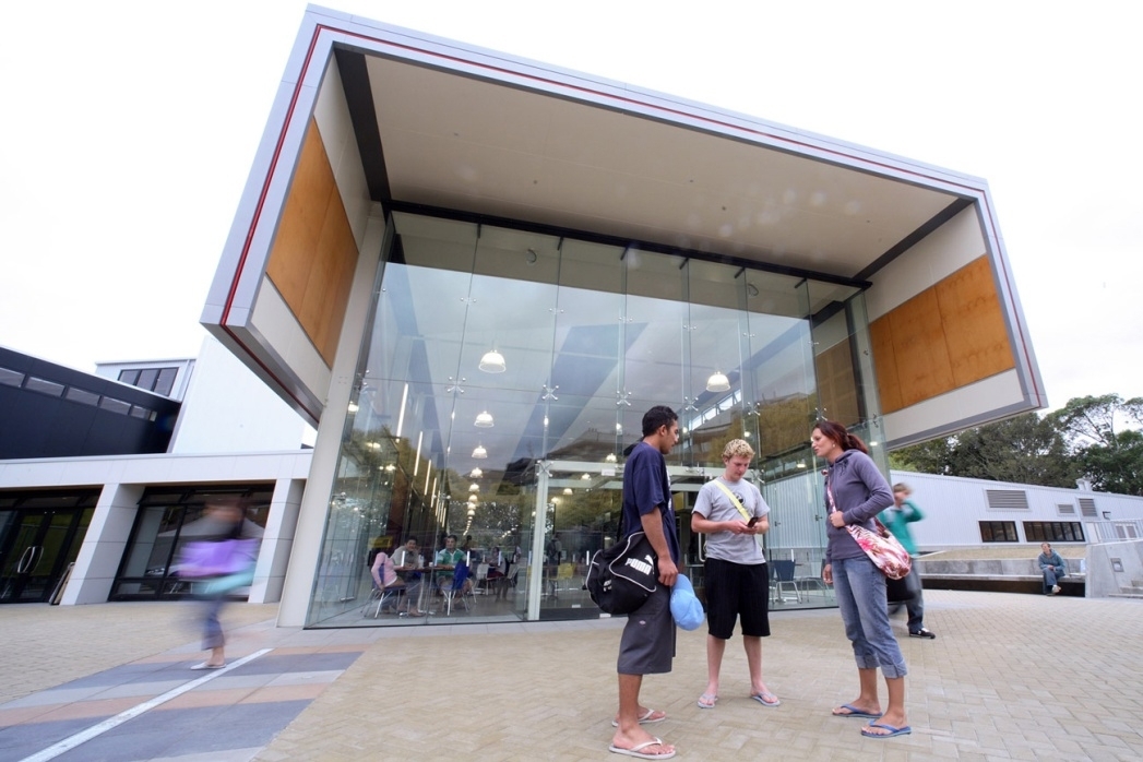 Students outside a building on the Manawatu Campus of Massey University in Palmerston North, New Zealand.
