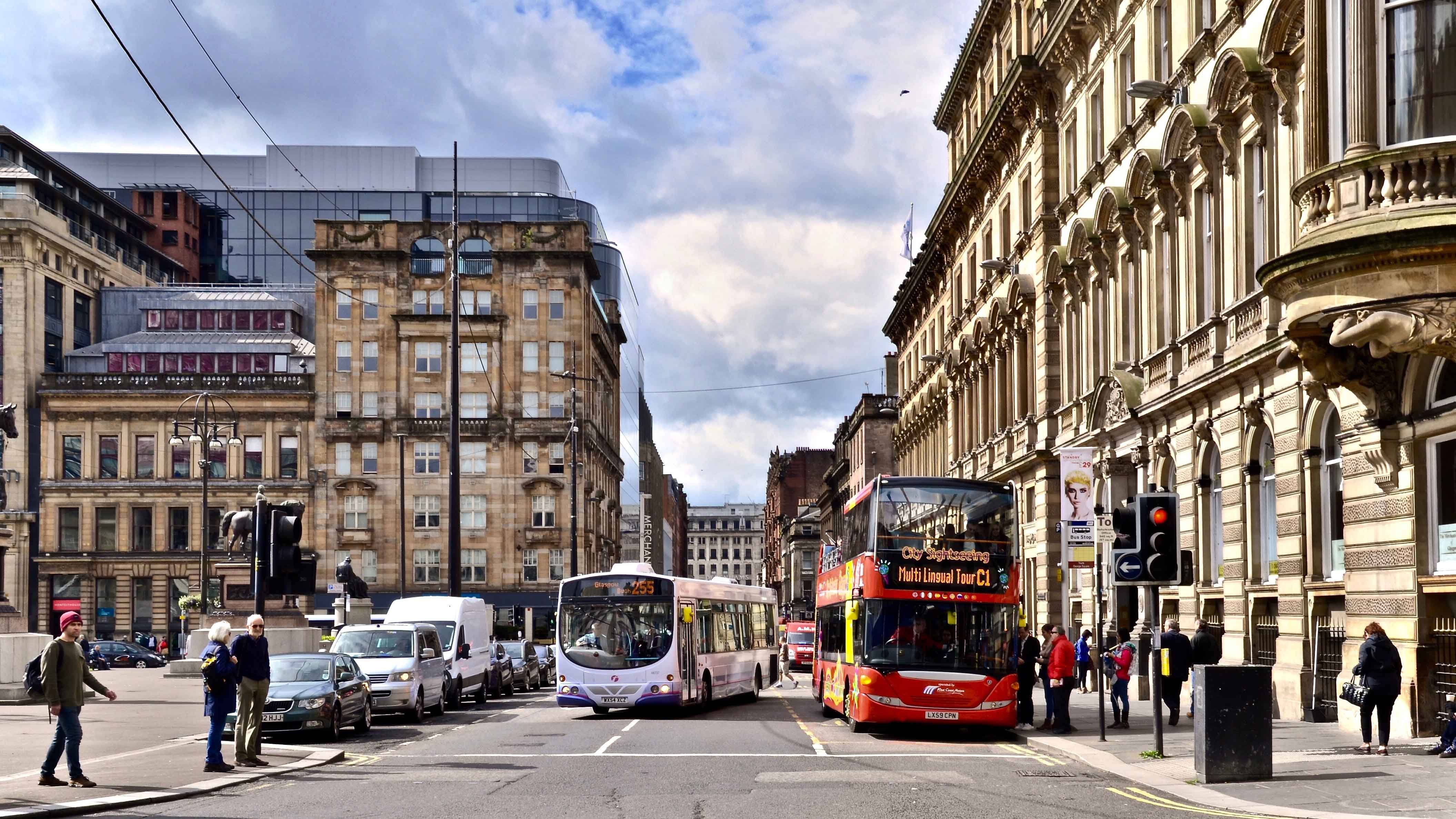 Busy city street with busses in Glasgow, Scotland.