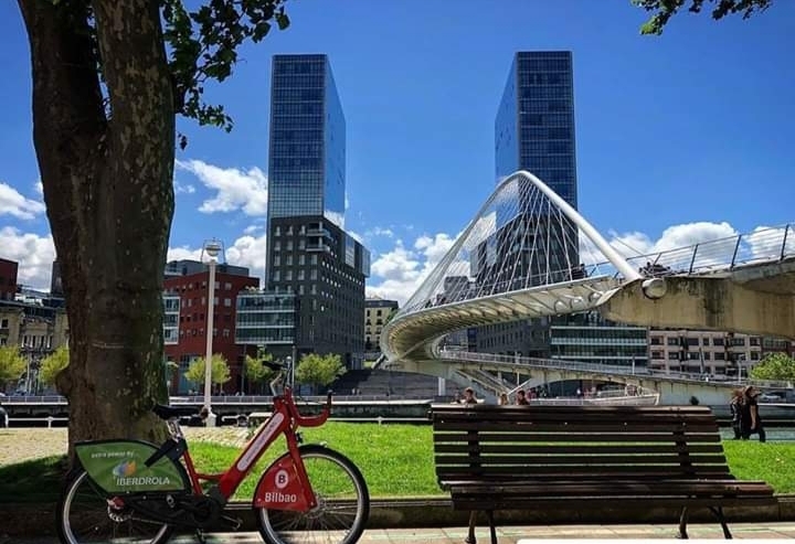 A view of a bike with buildings in the background in downtown Bilbao, Spain.
