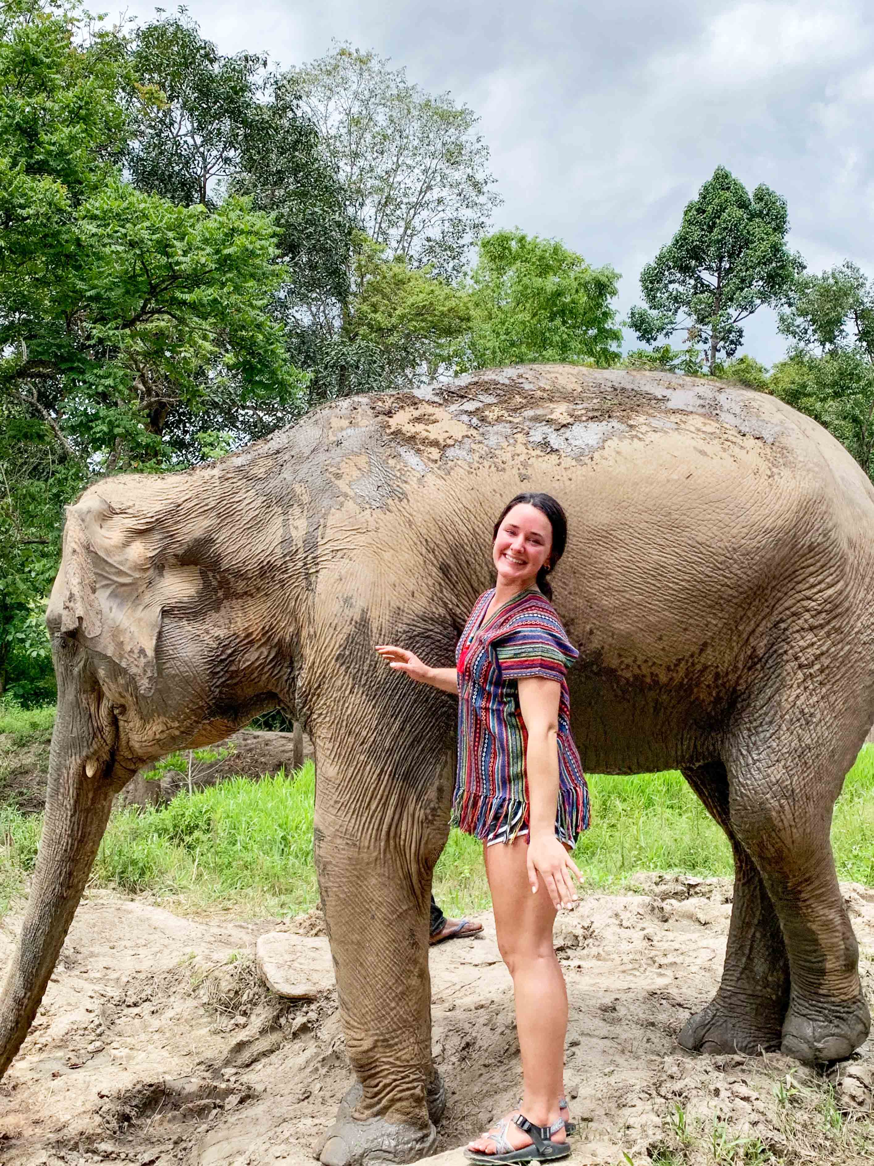 A student taking care of an elephant in Chiang Mai, Thailand.