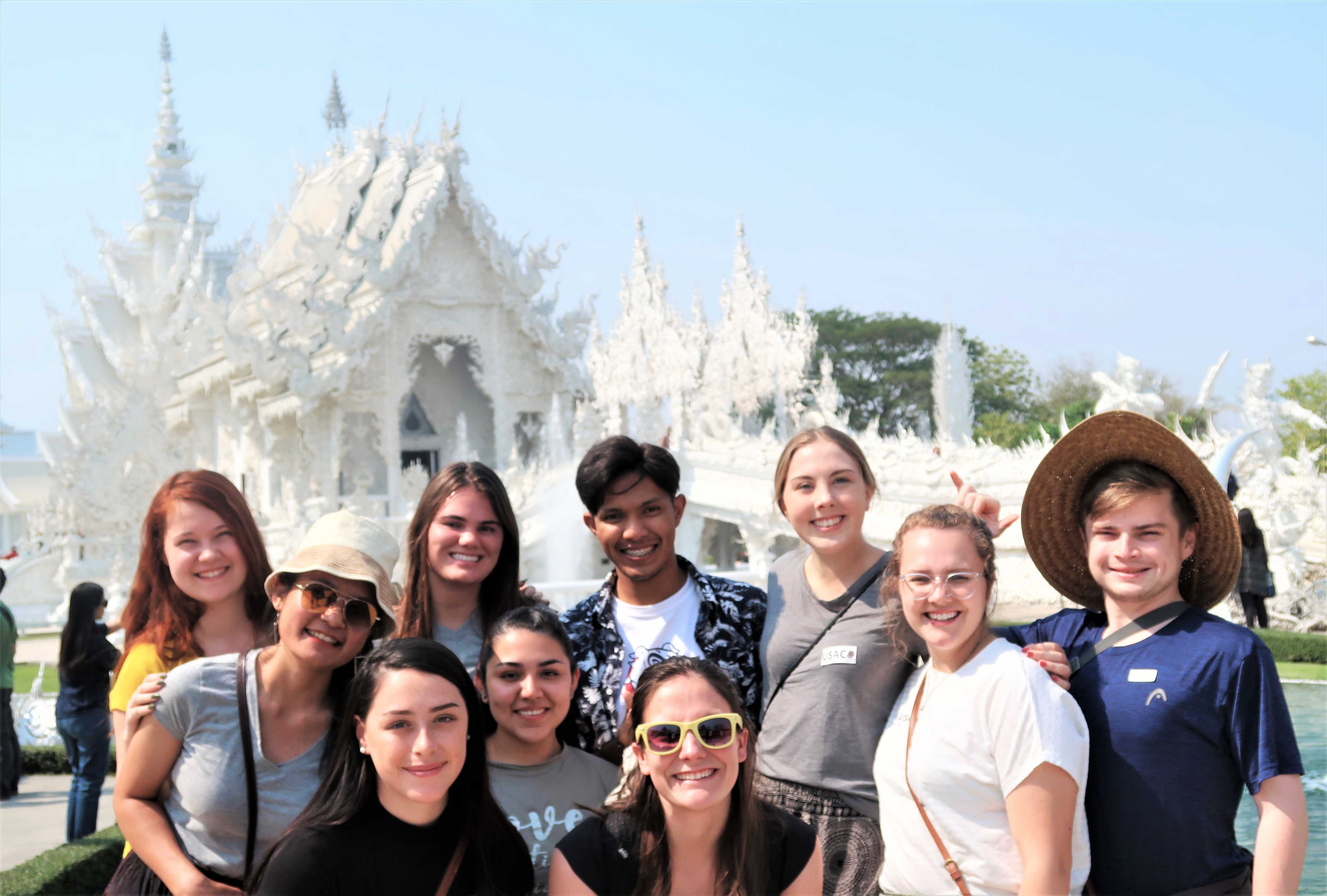 Students in front the famous white temple in Chiang Rai, Thailand.