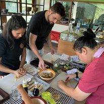 Students learning to make traditional Thai food in Chiang Mai, Thailand.