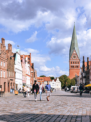 People walking down a cobblestone street in Germany.