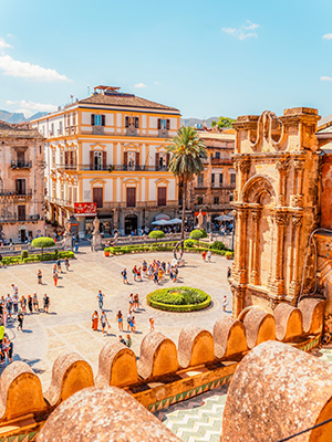 Historic buildings around a square in Italy.
